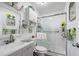 Bright bathroom with glass-enclosed shower, decorative mirror and fixtures, and ample storage at 27437 Dutch Ave, Punta Gorda, FL 33982
