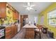 Bright kitchen featuring wood cabinets, stainless steel appliances, marble countertops and center island with seating at 27437 Dutch Ave, Punta Gorda, FL 33982