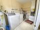Laundry room with washer, dryer, and ample shelving at 22239 Midway Blvd, Port Charlotte, FL 33952