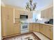 Bright kitchen with light wood cabinets, updated appliances, and a tiled floor at 22239 Midway Blvd, Port Charlotte, FL 33952