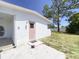 Exterior view of home with pink door and landscaping at 22239 Midway Blvd, Port Charlotte, FL 33952