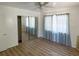 Well-lit bedroom featuring wood-look floors and mirrored closet doors at 22239 Midway Blvd, Port Charlotte, FL 33952