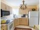Bright kitchen with white cabinets and a charming chandelier at 22239 Midway Blvd, Port Charlotte, FL 33952