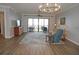 Relaxing living room with hardwood floors, access to a balcony with water views, and ample natural light at 87 Vivante Blvd # 8742, Punta Gorda, FL 33950