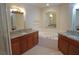 Elegant bathroom with granite countertops, double sinks, and a large soaking tub at 87 Vivante Blvd # 8742, Punta Gorda, FL 33950