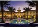 Luxury community building with a pool and fountain at night at 87 Vivante Blvd # 8742, Punta Gorda, FL 33950