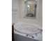 Oval soaking tub with jets in a tiled bathroom at 87 Vivante Blvd # 8742, Punta Gorda, FL 33950