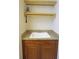 Laundry room with wooden cabinets, granite countertop, and shelving at 87 Vivante Blvd # 8742, Punta Gorda, FL 33950