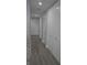 Long hallway with light grey wood flooring and multiple closets at 87 Vivante Blvd # 8742, Punta Gorda, FL 33950