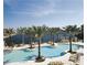 Resort-style pool and deck area with lounge chairs and palm trees at 87 Vivante Blvd # 8742, Punta Gorda, FL 33950