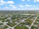 Expansive aerial shot highlighting the residential neighborhood and the surrounding natural landscape at 13348 Rayburn Ln, Port Charlotte, FL 33981