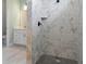 Modern walk-in shower featuring marble-look tile and a black shower head and fixtures at 13348 Rayburn Ln, Port Charlotte, FL 33981