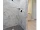Modern walk-in shower featuring marble-look tile and a black shower head and fixtures at 13348 Rayburn Ln, Port Charlotte, FL 33981