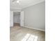 Spacious bedroom features wood-look tile flooring, neutral walls and modern ceiling fan at 13348 Rayburn Ln, Port Charlotte, FL 33981
