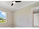 This bedroom features a modern ceiling fan, window with a view, and light woodgrain flooring at 13348 Rayburn Ln, Port Charlotte, FL 33981