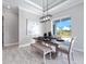 Bright dining room featuring modern chandelier, stylish decor and sliding glass door at 13348 Rayburn Ln, Port Charlotte, FL 33981