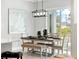 Charming dining room with a modern chandelier and a sliding glass door leading to the backyard at 13348 Rayburn Ln, Port Charlotte, FL 33981