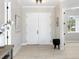 Bright foyer features double doors, wood-look tile flooring and neutral paint at 13348 Rayburn Ln, Port Charlotte, FL 33981