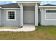 Charming home entrance with a covered porch and neutral color scheme at 13348 Rayburn Ln, Port Charlotte, FL 33981