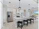 Stylish kitchen boasts modern white cabinetry, stainless appliances and island seating at 13348 Rayburn Ln, Port Charlotte, FL 33981