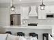 Modern kitchen featuring an island with bar seating, white cabinets, stainless appliances, and pendant lighting at 13348 Rayburn Ln, Port Charlotte, FL 33981