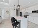 Open kitchen with white cabinets, stainless steel appliances and a spacious island at 13348 Rayburn Ln, Port Charlotte, FL 33981