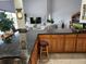 Open kitchen with breakfast bar, granite counters, and wood cabinets at 65 Ocean Dr, Punta Gorda, FL 33950