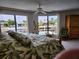 Main bedroom with water views and large bed, showcasing tropical bedding at 65 Ocean Dr, Punta Gorda, FL 33950