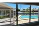 Stunning water view from window, showcasing pool, canal, and boats at 65 Ocean Dr, Punta Gorda, FL 33950