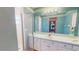 Bathroom featuring a shower, vanity, framed mirror, and ample counter space at 7263 Sablon Rd, North Port, FL 34291
