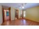 Bedroom featuring wood floors, a ceiling fan, and three doors at 7263 Sablon Rd, North Port, FL 34291