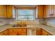 Bright kitchen features granite countertops, stainless steel appliances, and a window overlooking the backyard at 7263 Sablon Rd, North Port, FL 34291