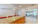 Granite countertops and oak cabinetry complement this open-concept kitchen at 7263 Sablon Rd, North Port, FL 34291