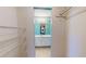 Open walk-in closet featuring rod and wire shelving, with a view into the bathroom at 7263 Sablon Rd, North Port, FL 34291