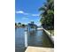 Private boat lift on a canal with lush tropical landscaping at 65 Ocean Dr, Punta Gorda, FL 33950