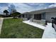 Brick ranch home with gray roof, landscaping, and walkway at 4419 Crews Ct, Port Charlotte, FL 33952