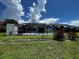 Screened-in pool area with grassy backyard at 4419 Crews Ct, Port Charlotte, FL 33952