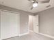 Spacious bedroom with ceiling fan, double closet, and wood-look tile floors at 820 Bowman Ter, Port Charlotte, FL 33953