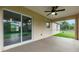 Spacious screened porch with ceiling fan and view of backyard at 820 Bowman Ter, Port Charlotte, FL 33953