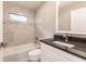 Updated bathroom with tub, single vanity, and granite countertop at 820 Bowman Ter, Port Charlotte, FL 33953