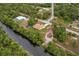 Aerial view of a single-Gathering home on a canal with lush landscaping at 820 Bowman Ter, Port Charlotte, FL 33953
