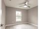 Bright bedroom with large window, ceiling fan, and wood-look tile floors at 820 Bowman Ter, Port Charlotte, FL 33953