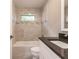 Updated bathroom with tub, single vanity, and granite countertop at 820 Bowman Ter, Port Charlotte, FL 33953