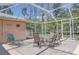 Screened patio with table and chairs at 7263 Sablon Rd, North Port, FL 34291