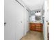 Guest bathroom with wood vanity and storage at 6405 Kilohee Ct, North Port, FL 34287