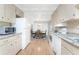 Kitchen features white appliances and granite countertops at 6405 Kilohee Ct, North Port, FL 34287