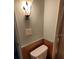 Simple bathroom with toilet and wall-mounted light at 6405 Kilohee Ct, North Port, FL 34287