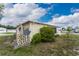 Tan mobile home with satellite dish and landscaped yard at 6405 Kilohee Ct, North Port, FL 34287