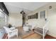 Relaxing screened porch furnished with white wicker furniture at 6405 Kilohee Ct, North Port, FL 34287