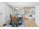 Bright dining area with glass table and four chairs near kitchen at 6405 Kilohee Ct, North Port, FL 34287